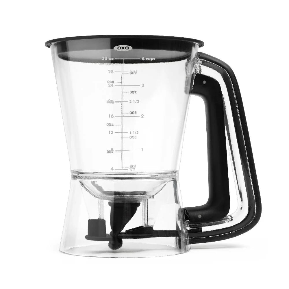 Clear batter dispenser with black handle and OXO logo on a white background