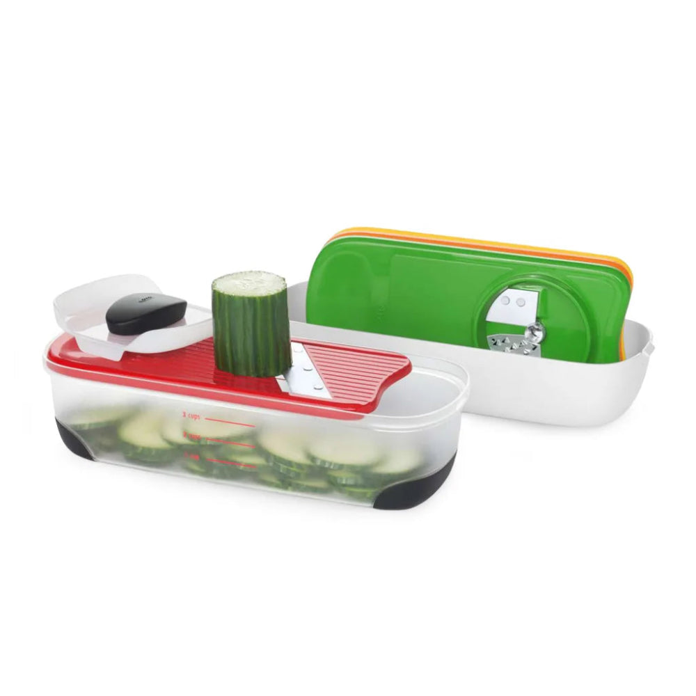 Vegetable slicer with a green container on a white background