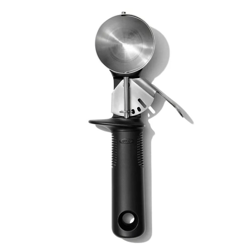 Metallic ice cream scoop with black handle on a white background