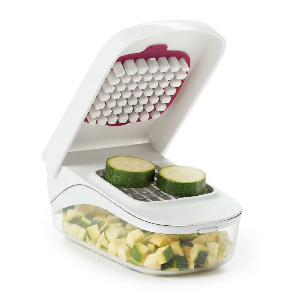 Vegetable chopper with zucchini slices on a white background