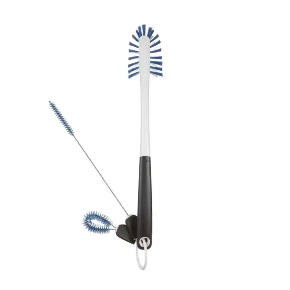 Two cleaning brushes with blue bristles on a white background