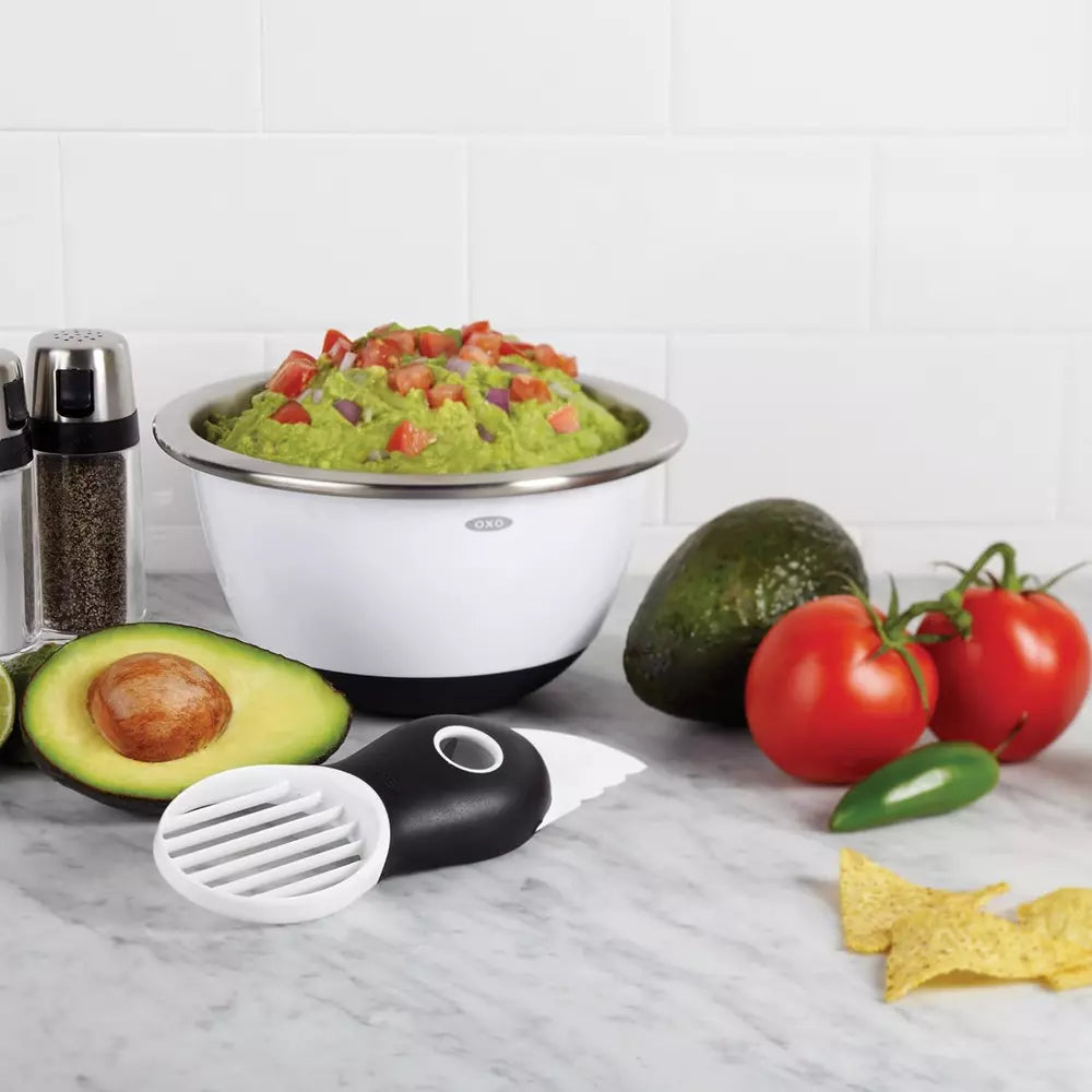 Oxo avocado slicer with vegetables and bowl with crushed avocado 