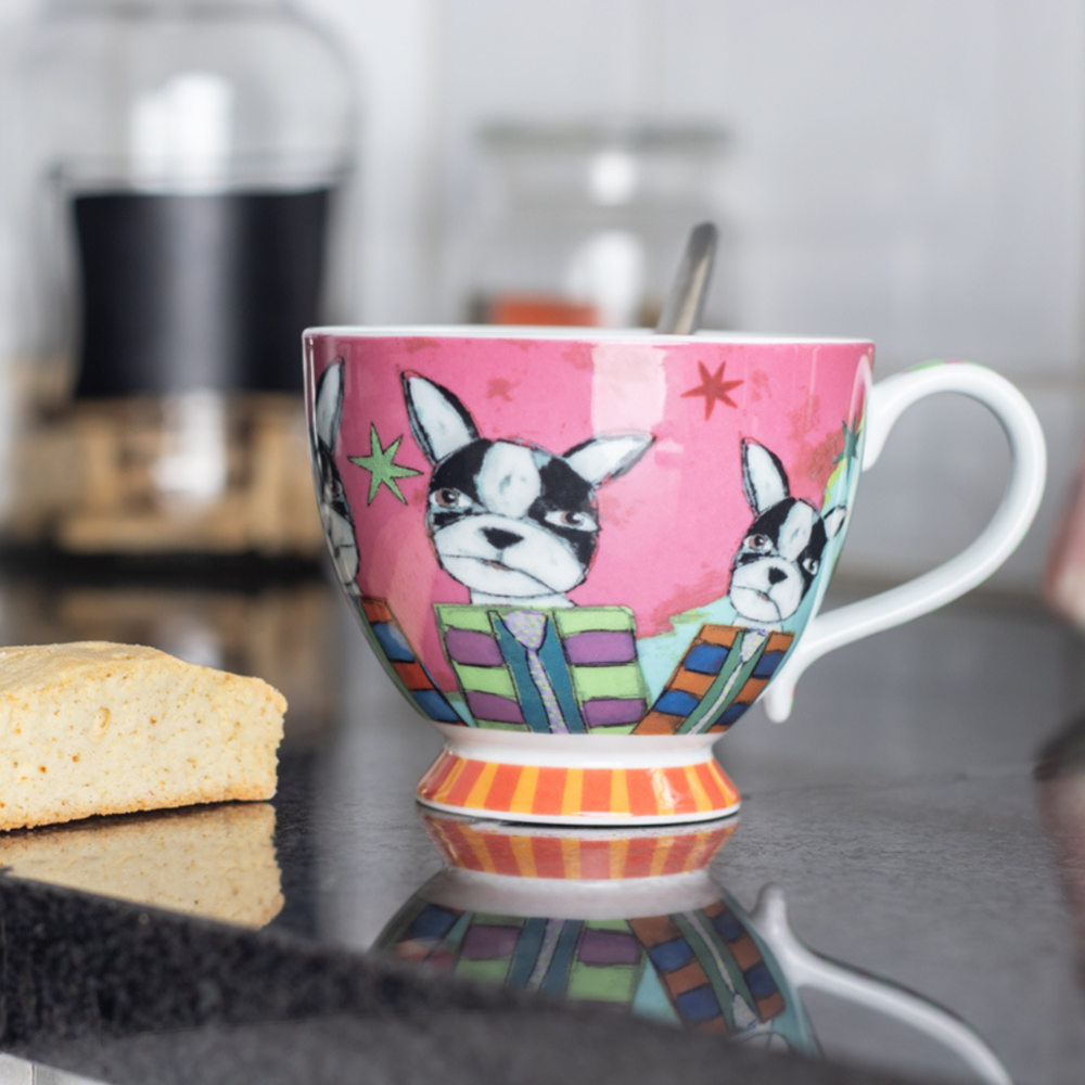 Colorful mug with dog design on a reflective surface
