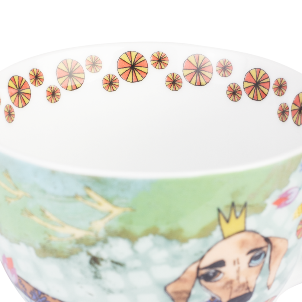 Ceramic bowl with a colorful design of a character with a crown and a landscape.