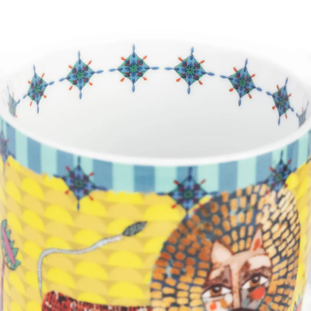 Ceramic mug with a colorful design of a fox and geometric patterns on a white background