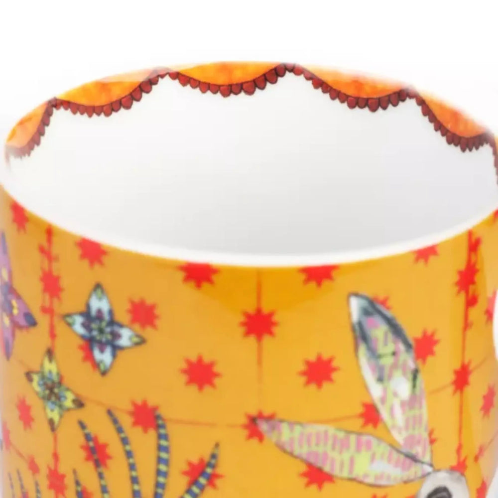 Ceramic mug with colorful design on a yellow background