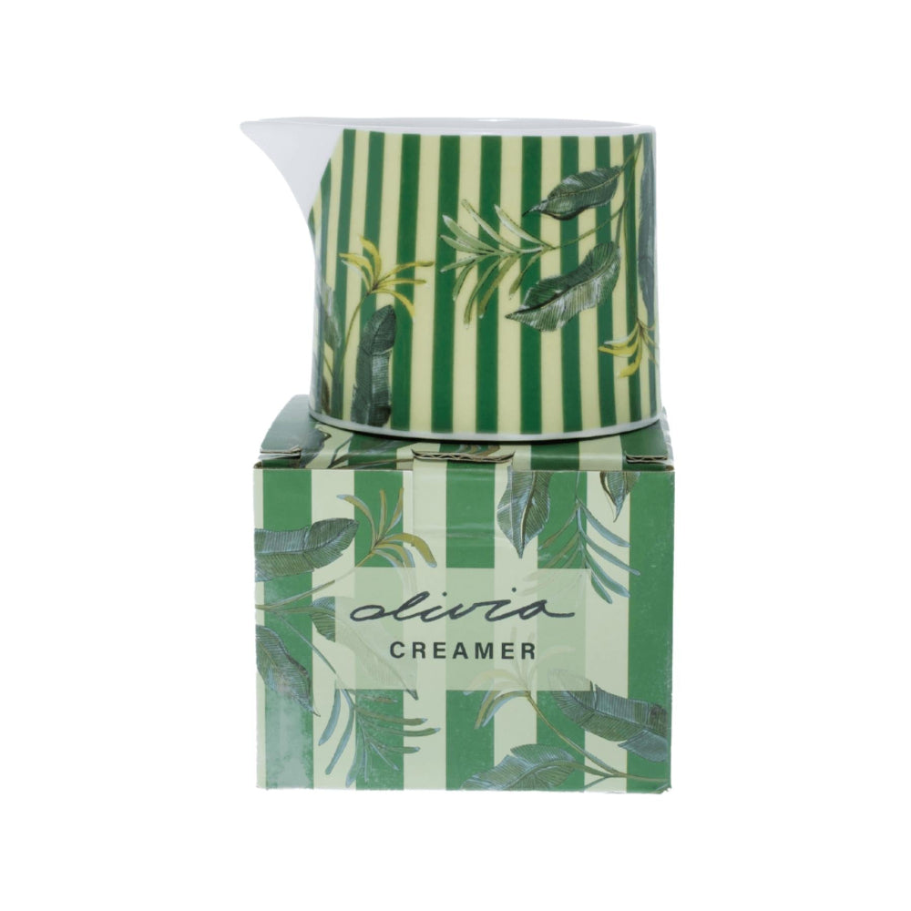 Green and white striped creamer with matching packaging on a white background