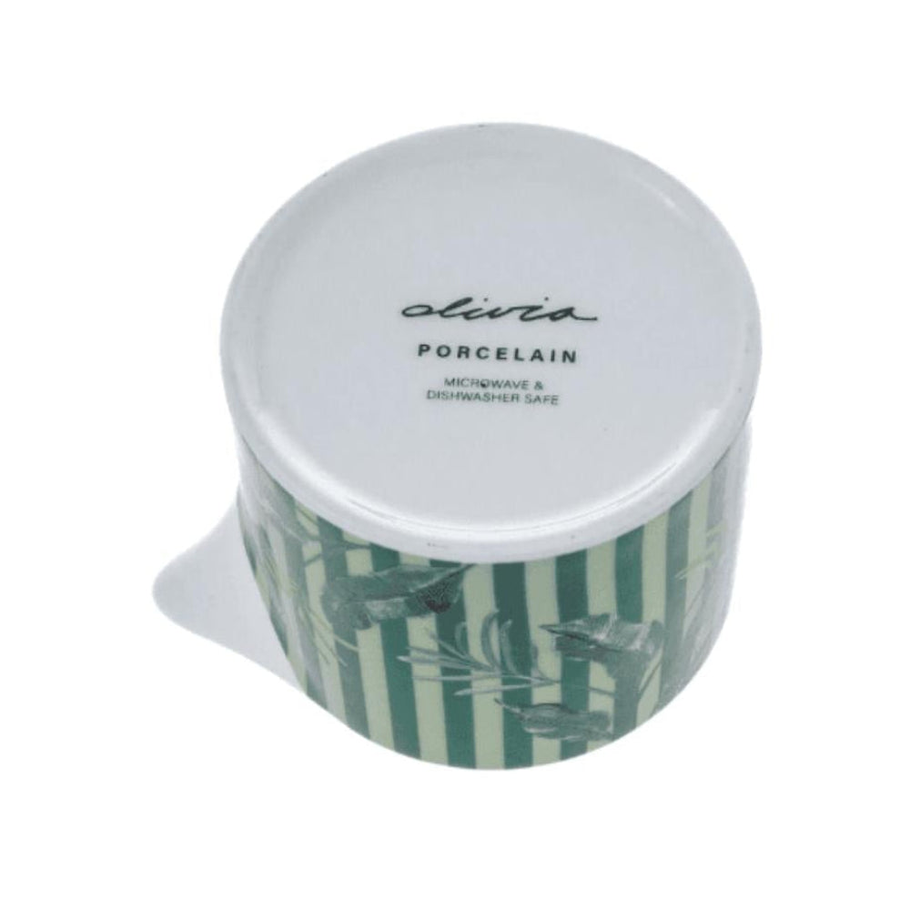 Green and white creamer with a lid on a white background