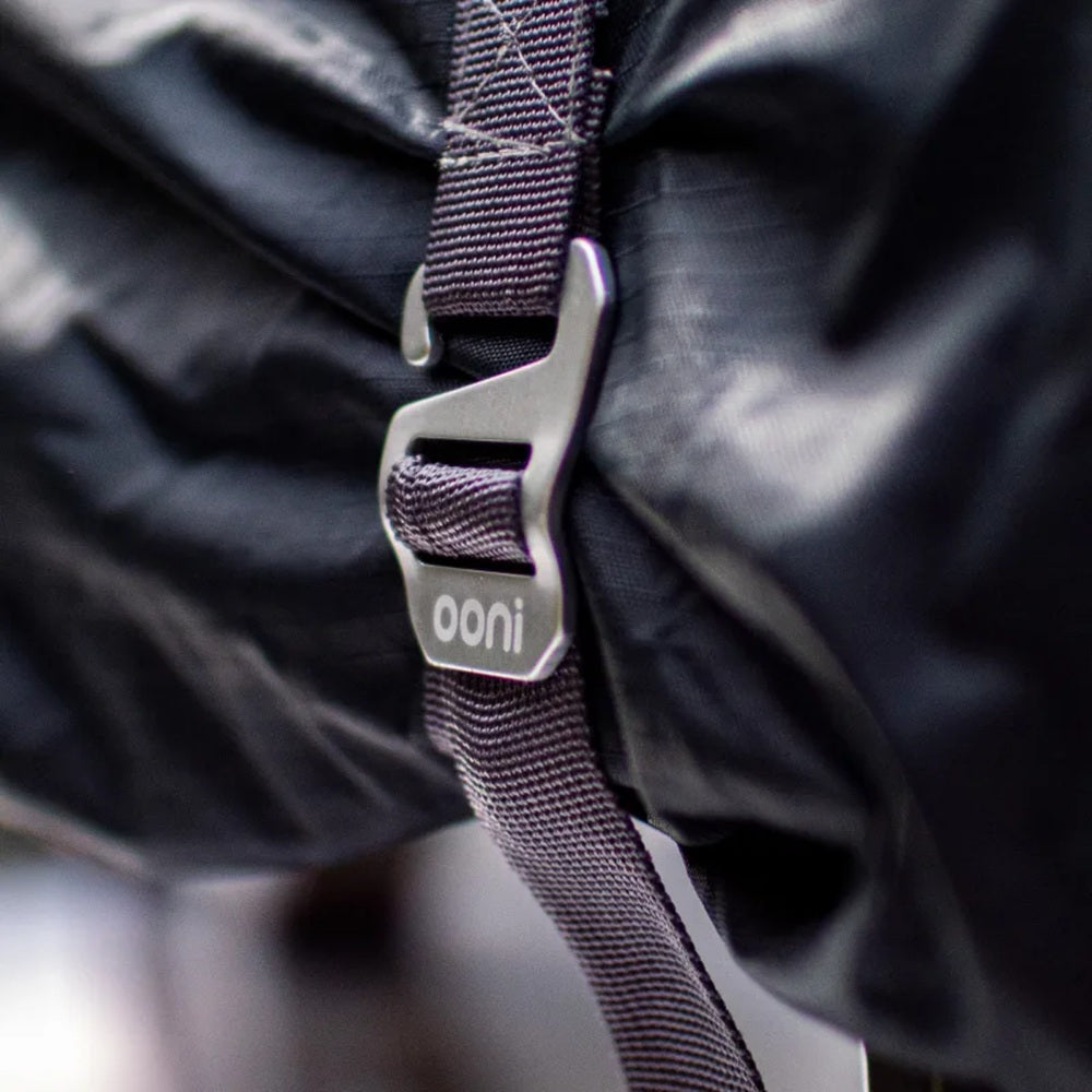 Close-up of a purple strap with 'ooni' logo on a black background
