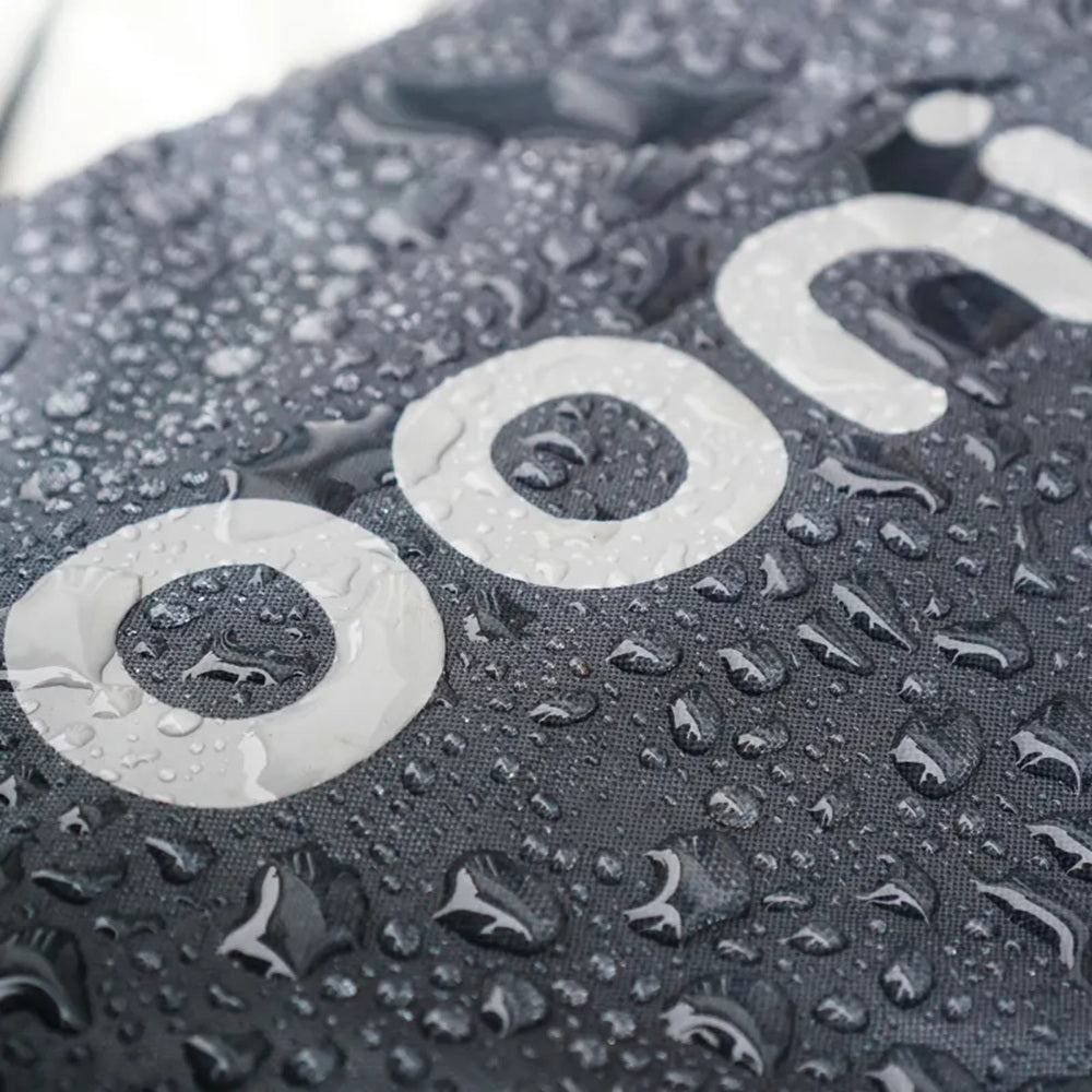 Close-up of a textured surface with water droplets and a brand logo.