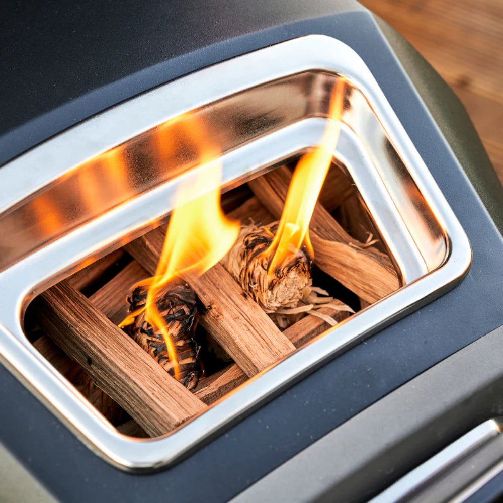 Close-up of a fire pit with wooden logs and flames inside a metal container.