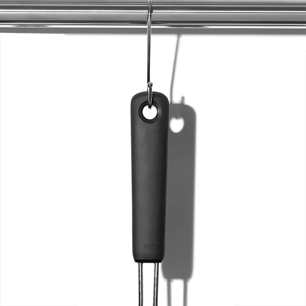 Kitchen utensil hanging from a metal rod on a white background