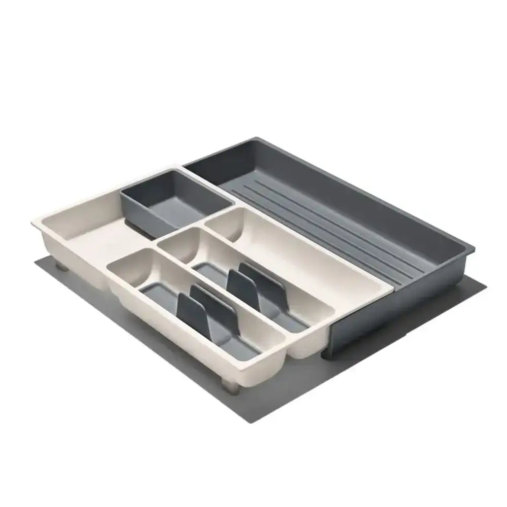 Kitchen drawer organizer with beige and gray compartments on a white background