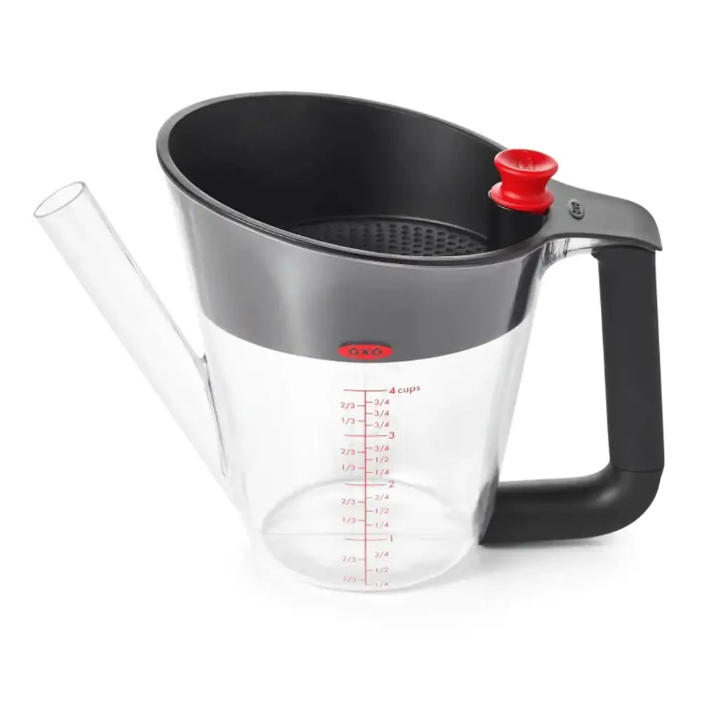 Clear measuring cup with black handle and red accents on a white background