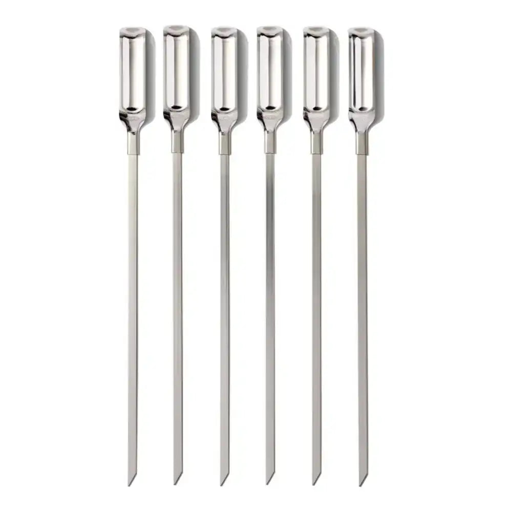 Set of six metal skewers on a white background