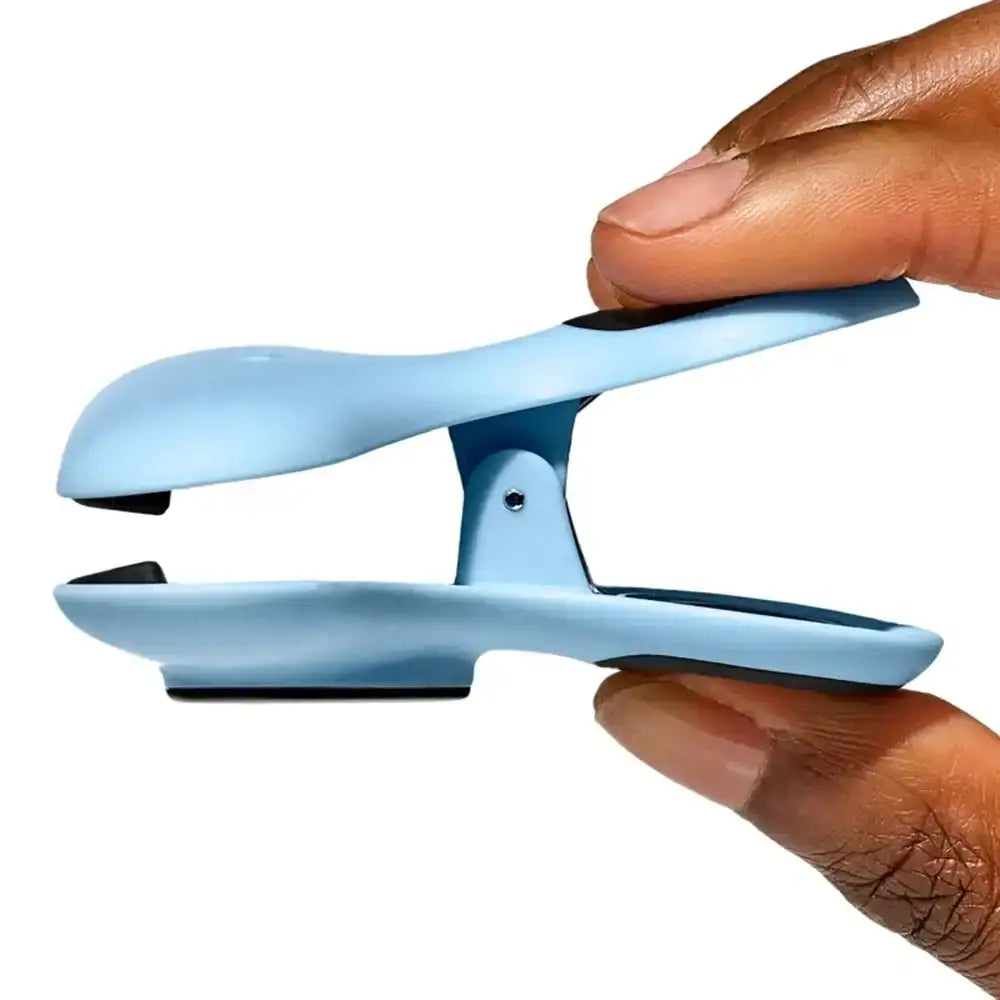 Light blue clip held by a hand on a white background