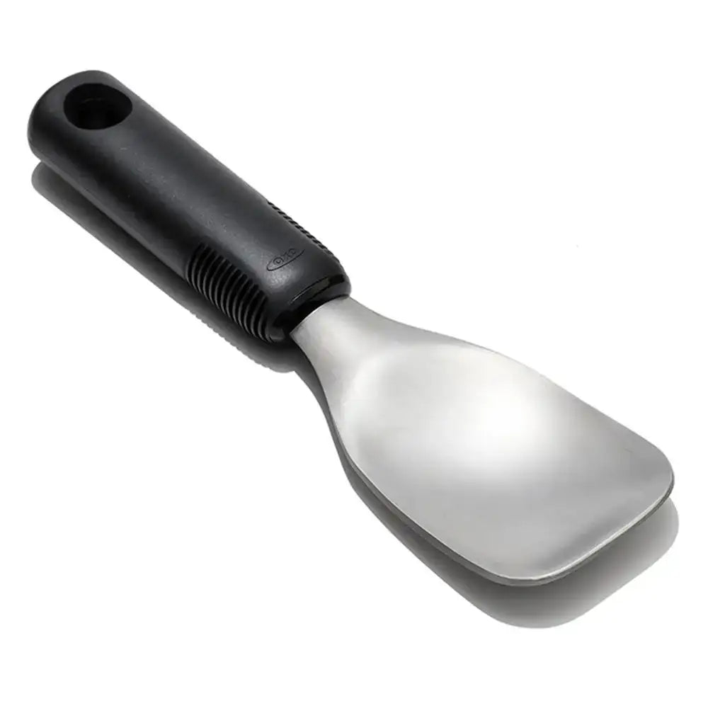 Metallic spoon with black handle on a white background