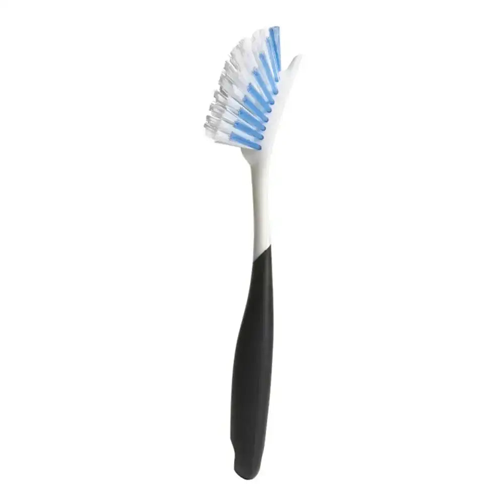 Dish brush with black handle and blue bristles on a white background