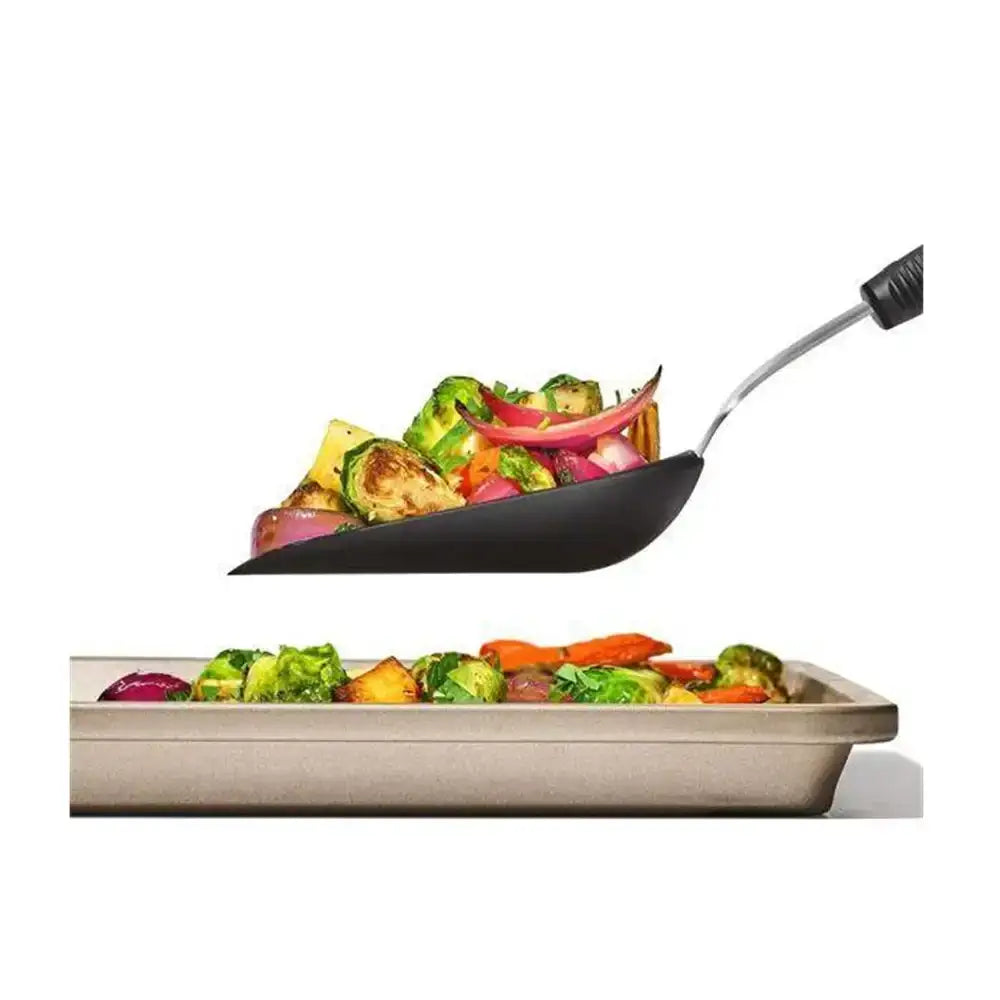 Frying pan with vegetables on a white background