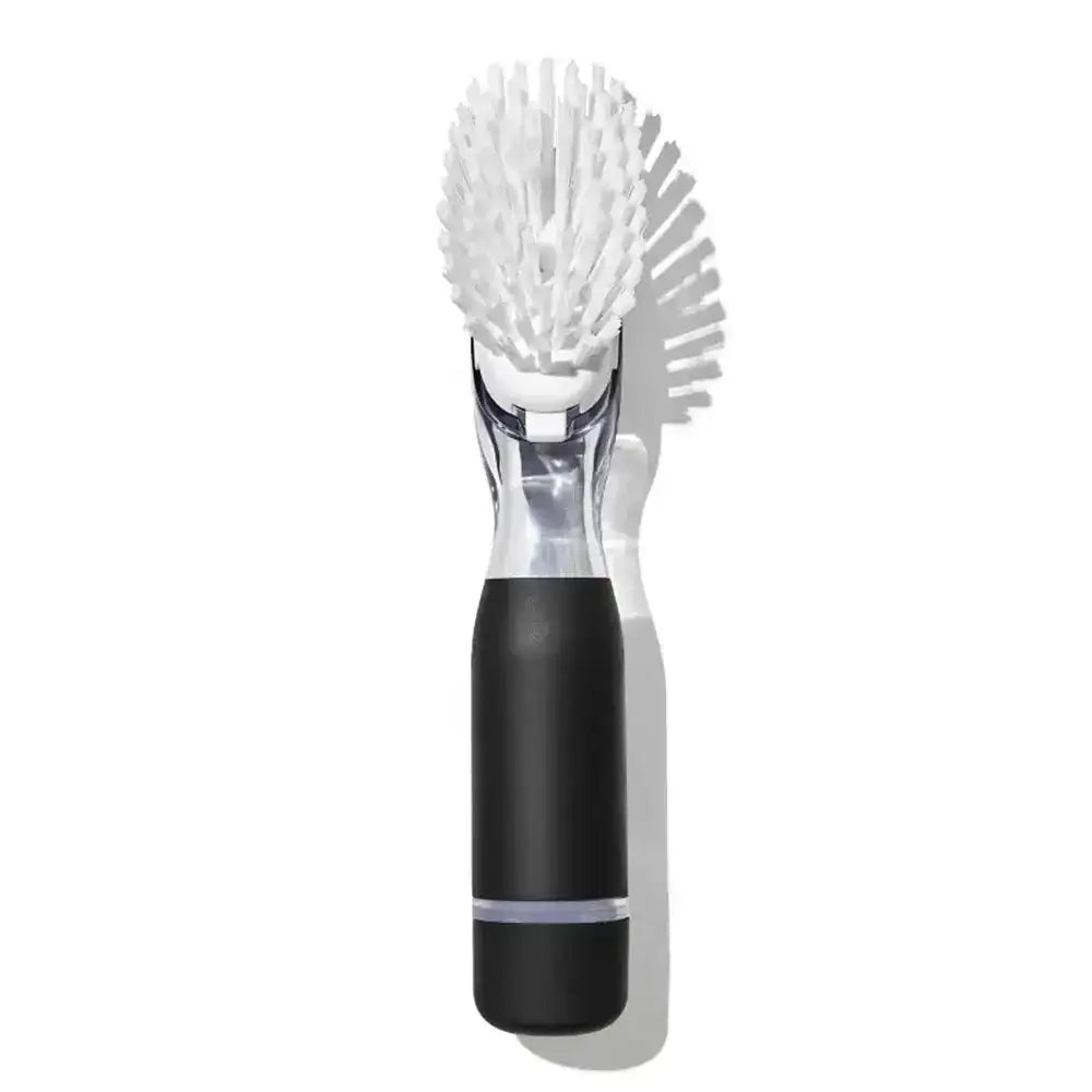 Cleaning brush with black handle and white bristles on a white background