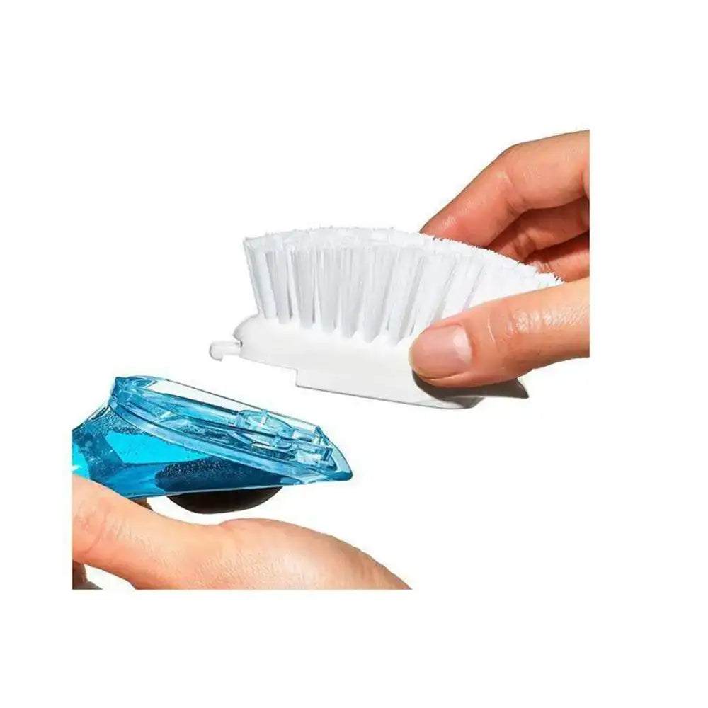 Cleaning brush with a white bristle head and blue handle, held by a hand on a white background.