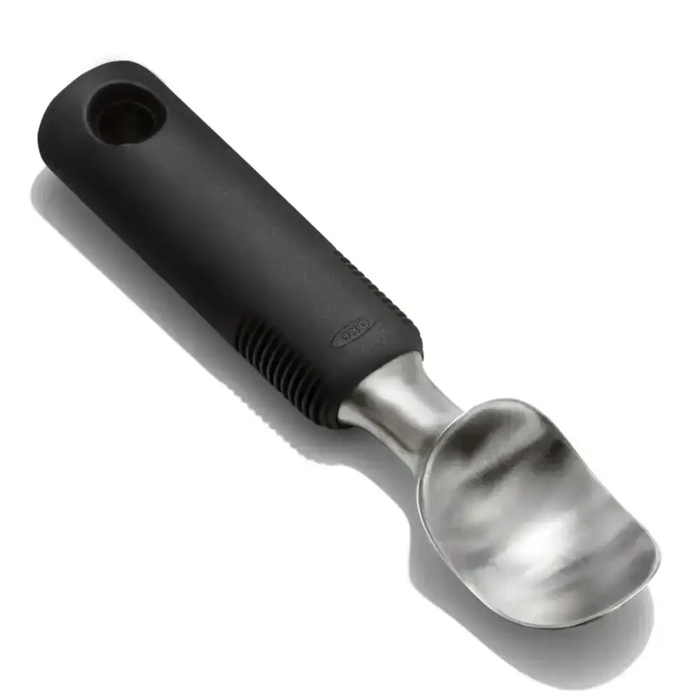 Black-handled metal ice cream scoop on a white background