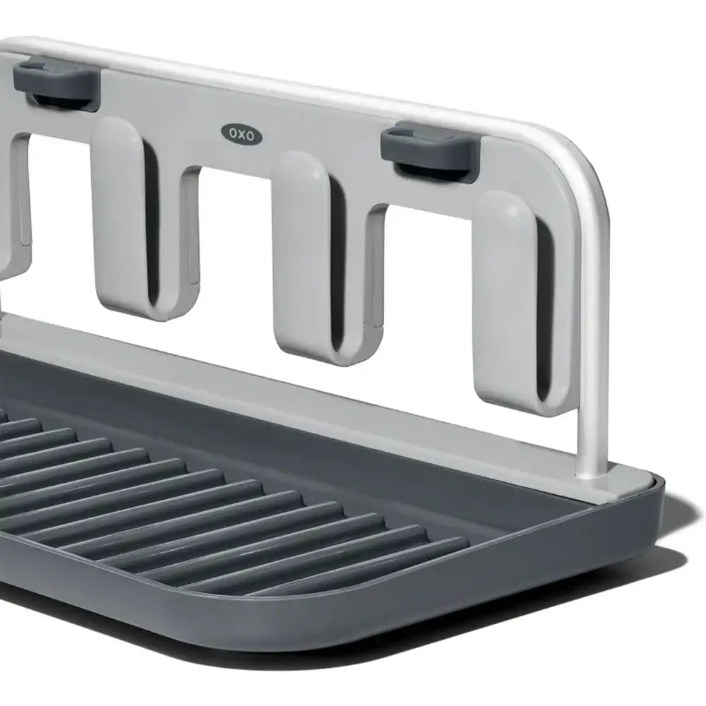 Gray and white dish rack with OXO branding on a white background