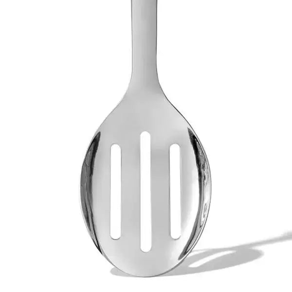 Oxo stainless steel slotted serving spoon in silver with three vertical slots and a smooth rounded handle