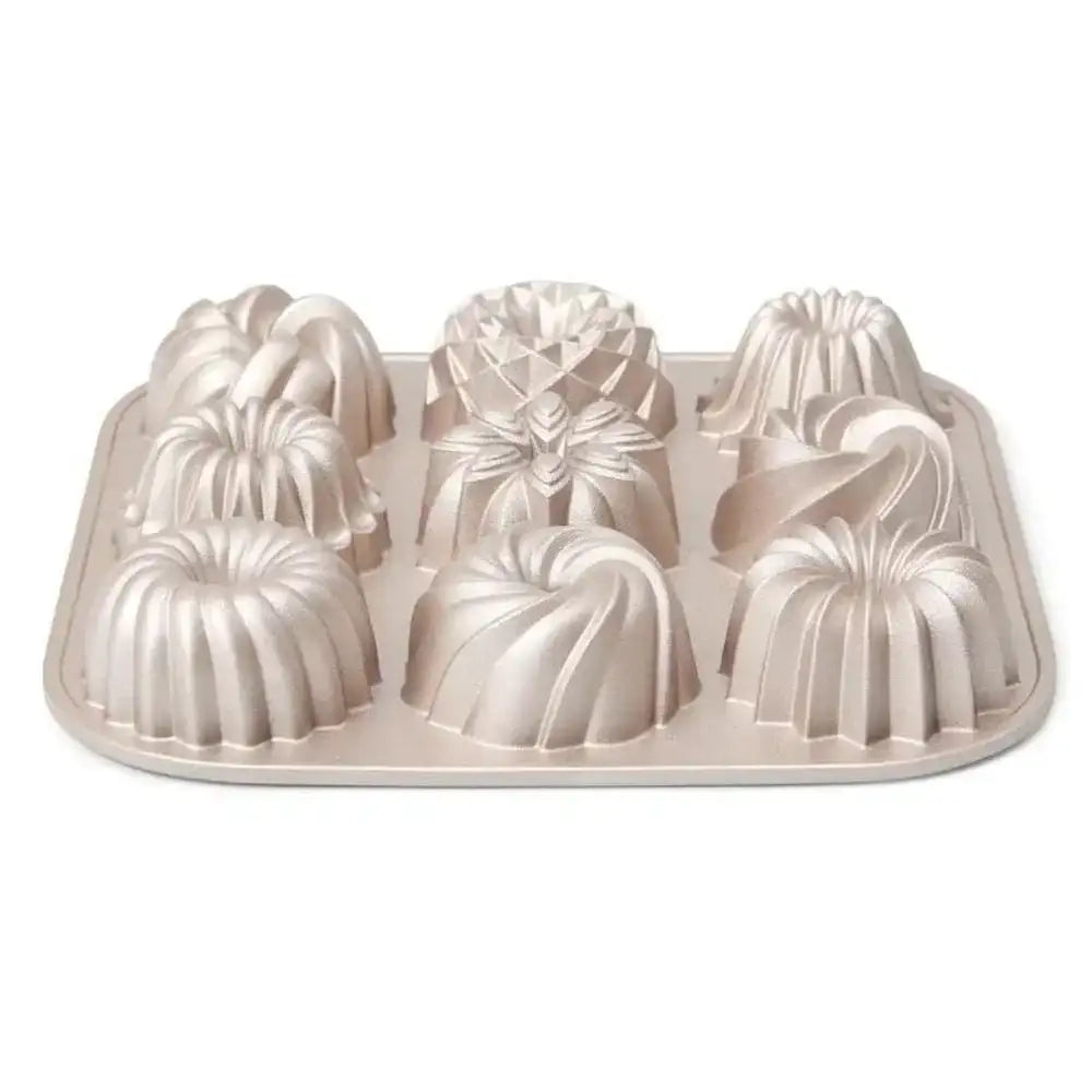 Metal cake mold with decorative shapes on a white background