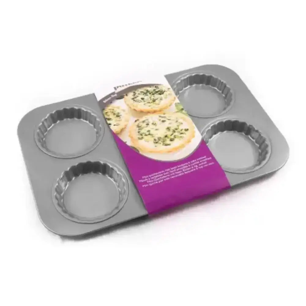 Metal tartlet pan with four compartments on a white background