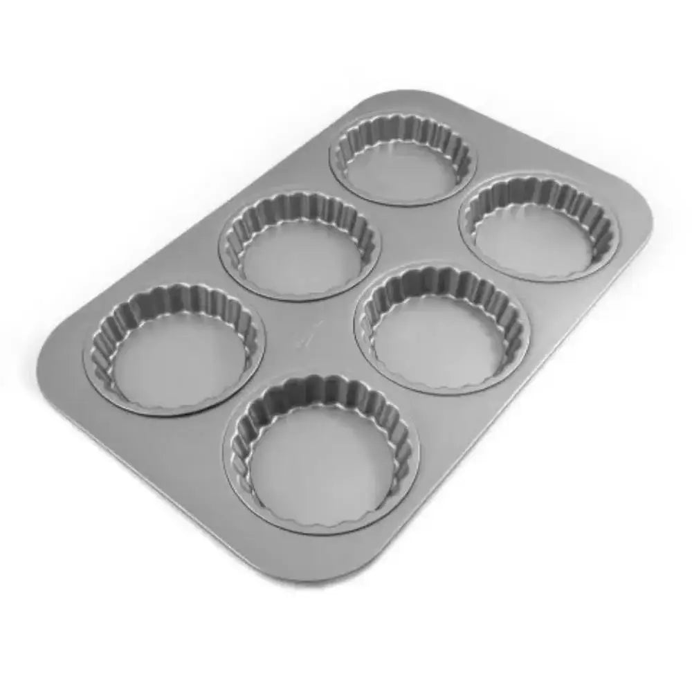 Metal muffin tin with six individual cups on a white background