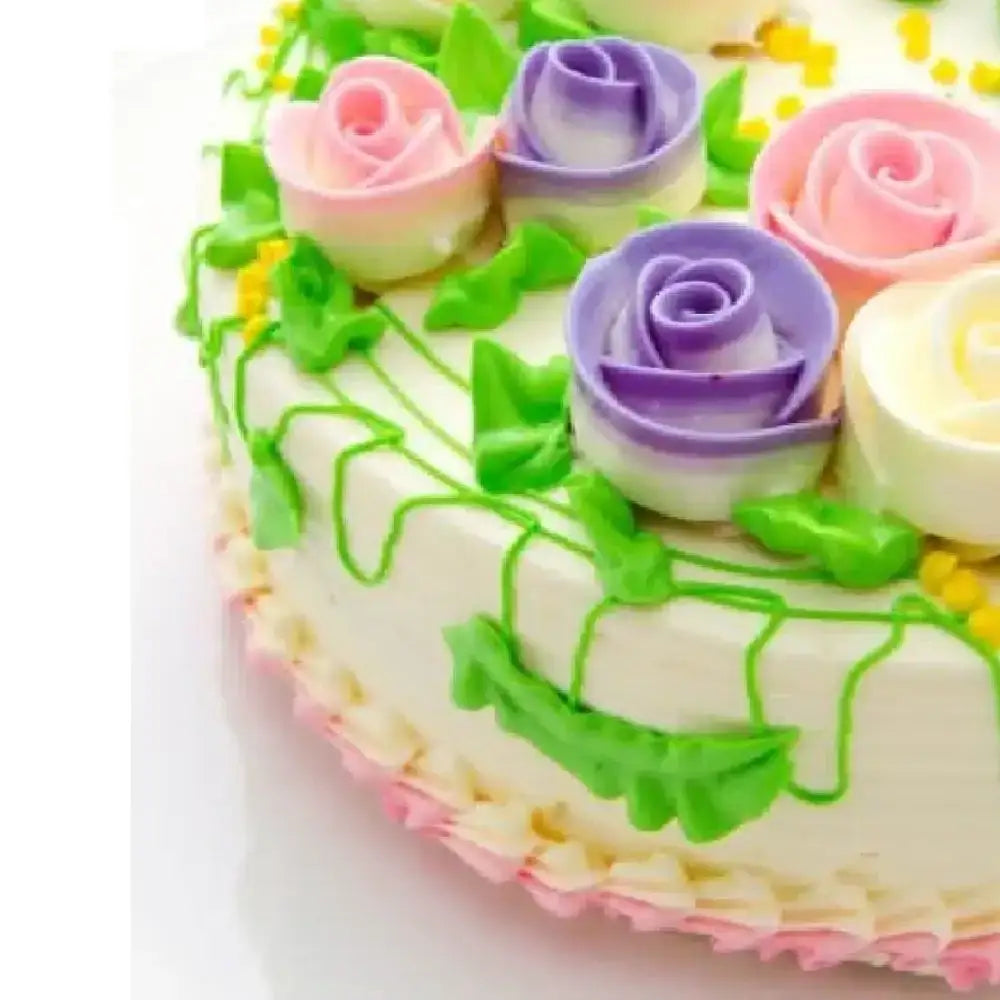 Decorative cake with colorful roses and green leaves on a white background