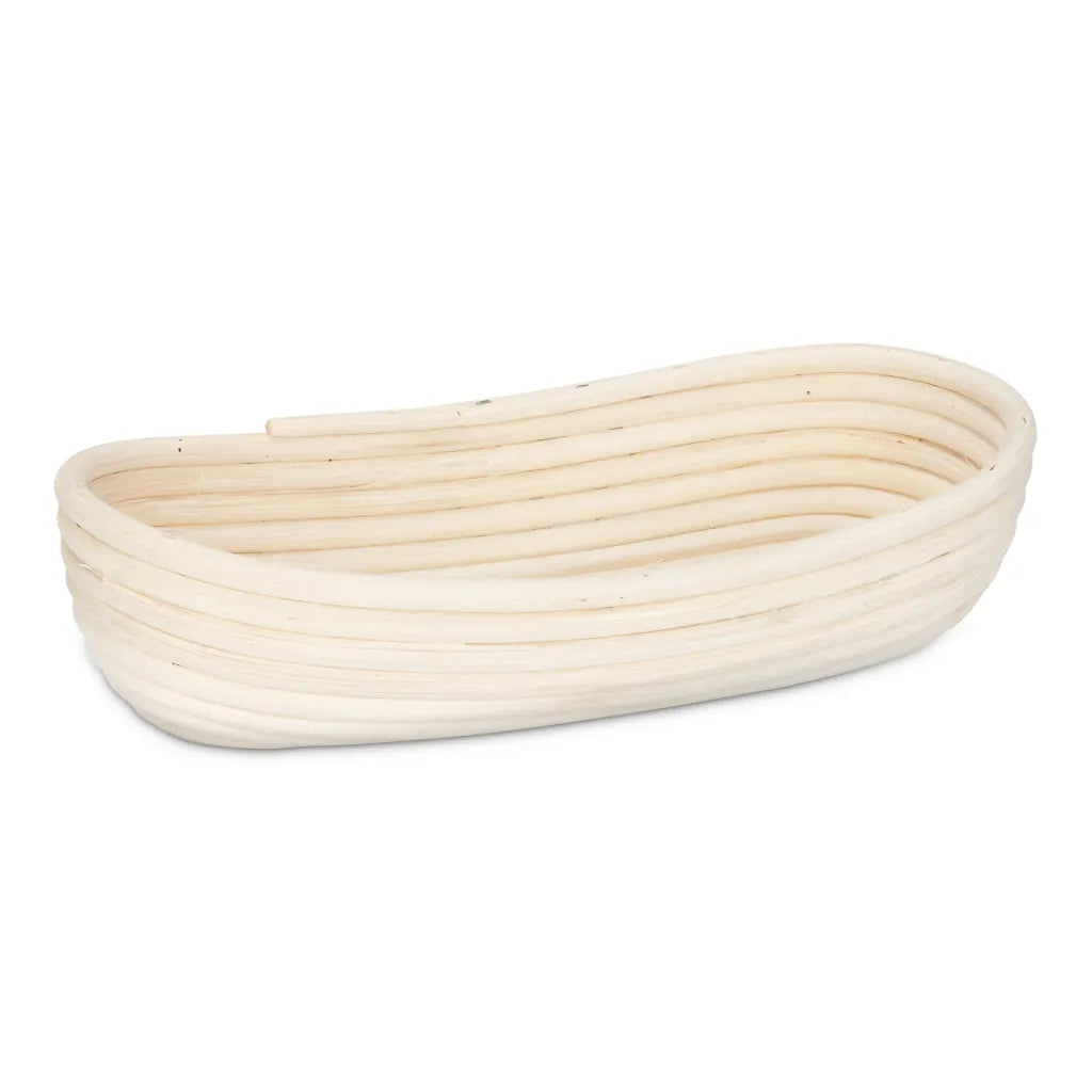 A natural woven rattan basket with a rounded, elongated shape, shown on a plain white background.