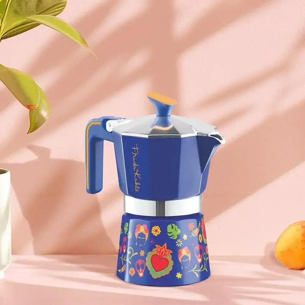 Blue coffee maker with colorful design on a pink background