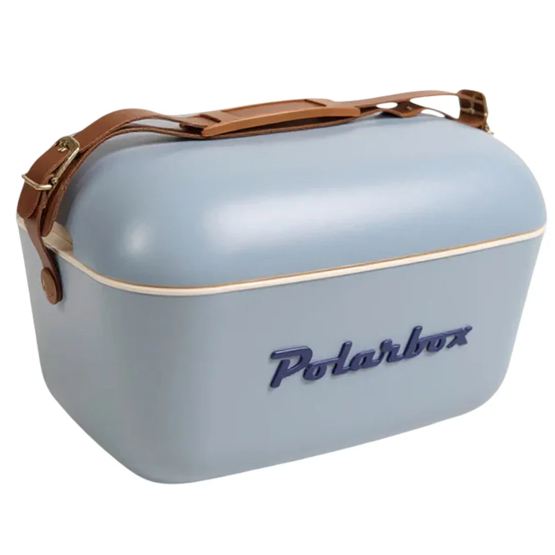 A light blue Polarbox cooler with a brown leather handle and strap, featuring the Polarbox logo in blue on the front.