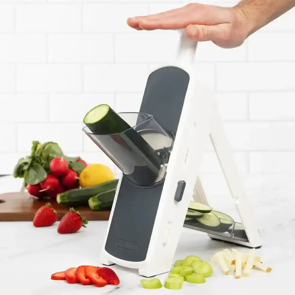 Vegetable chopper with sliced vegetables on a kitchen counter
