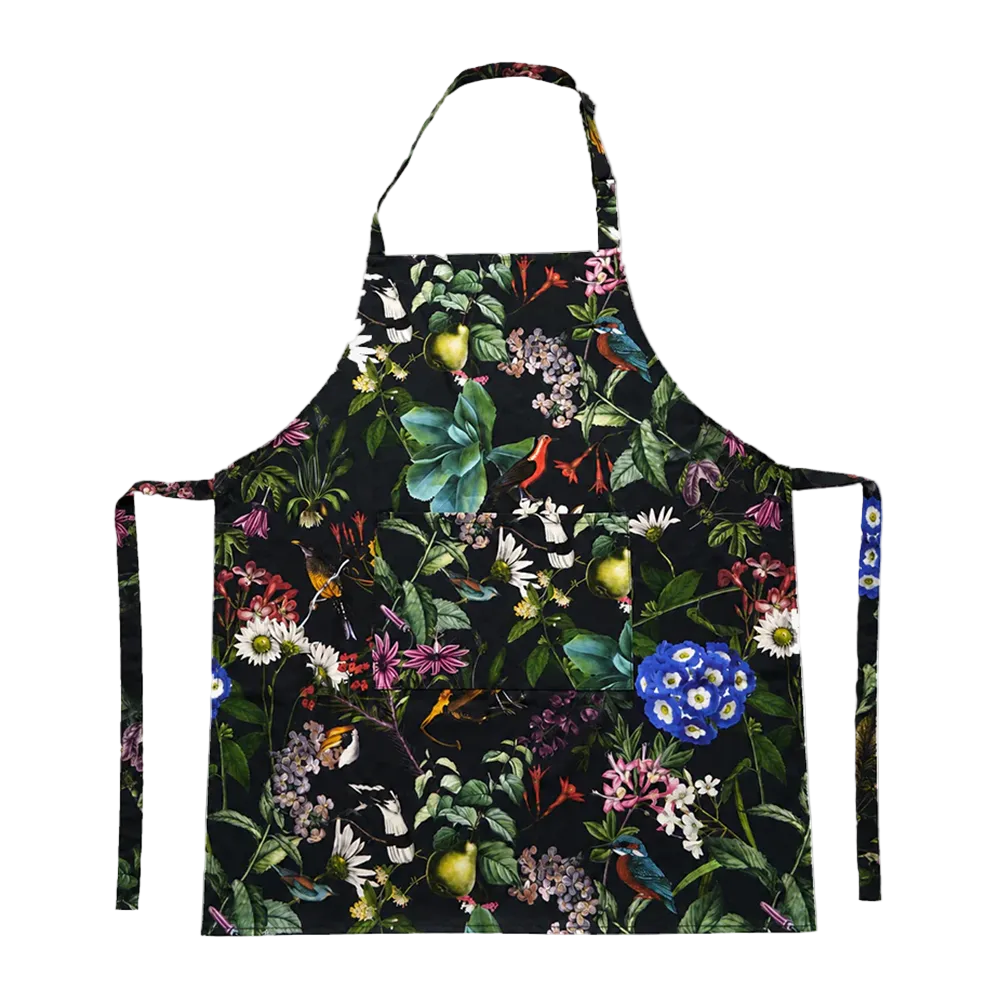 A black apron with a vibrant, dense botanical and bird pattern featuring green leaves, blue flowers, yellow fruits, and small birds, shown against a plain white background.
