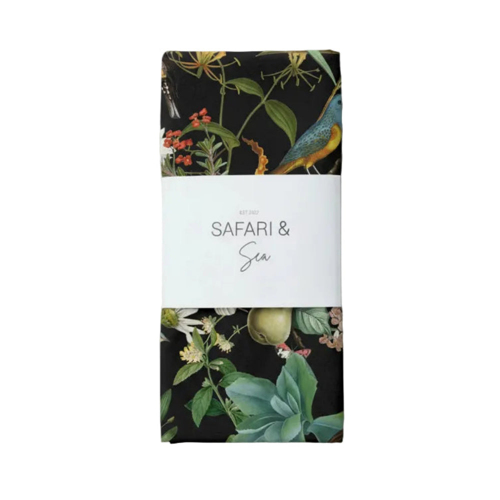 Tea towel with a floral design on the cover and 'Safari & Sea' text on a white background