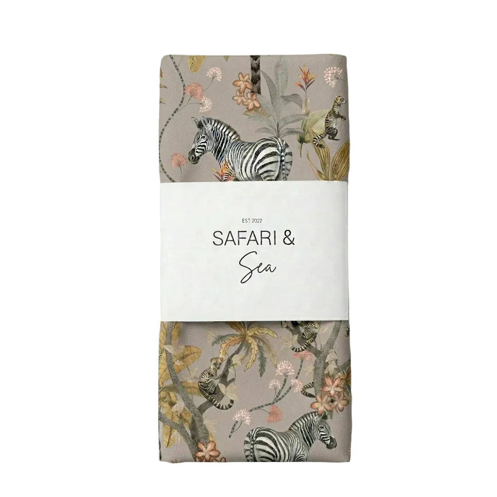 Packaged product with zebra and floral design on a light gray background