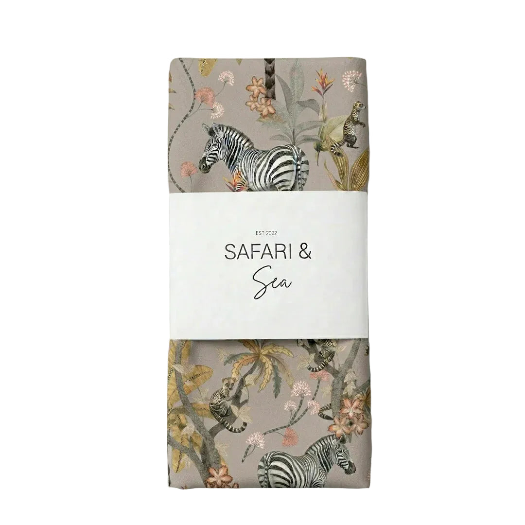 Packaged product with zebra and floral design on a light gray background