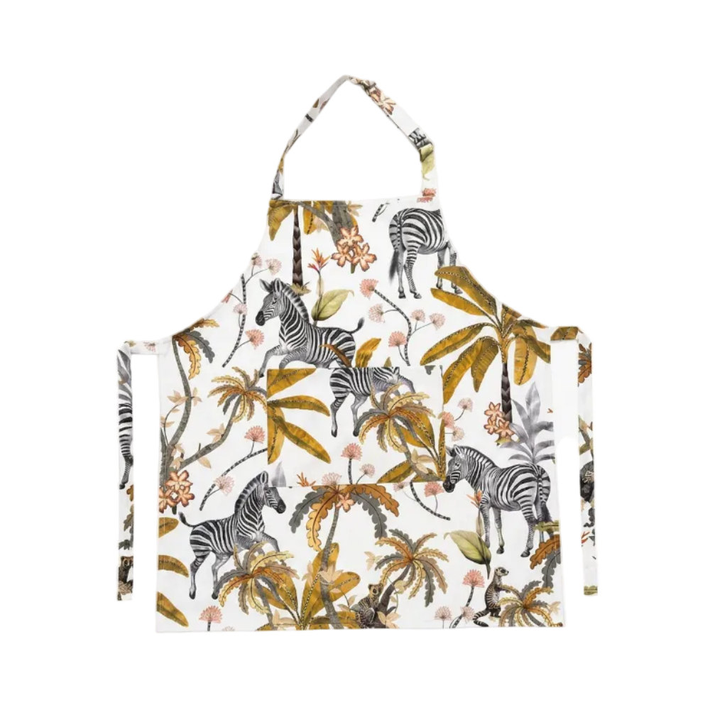 A white apron featuring a detailed safari print with zebras, palm trees, and tropical flowers in olive green, mustard yellow, and soft pink, shown against a plain white background.