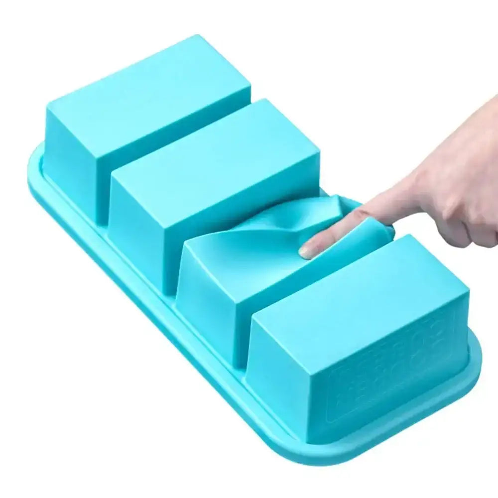 Blue silicone ice cube tray with a hand pointing at one of the compartments on a white background