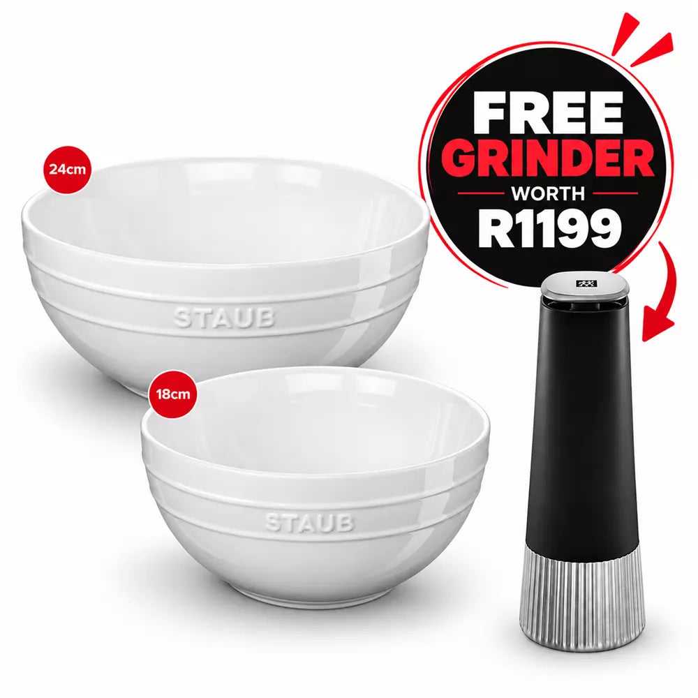 Two white Staub ceramic bowls, one 24cm and one 18cm, shown next to a black and silver electric grinder, with a promotional badge offering a free grinder worth R1199.