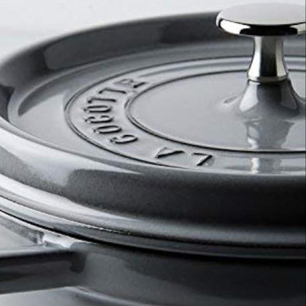Gray Staub cocotte with lid on a white background