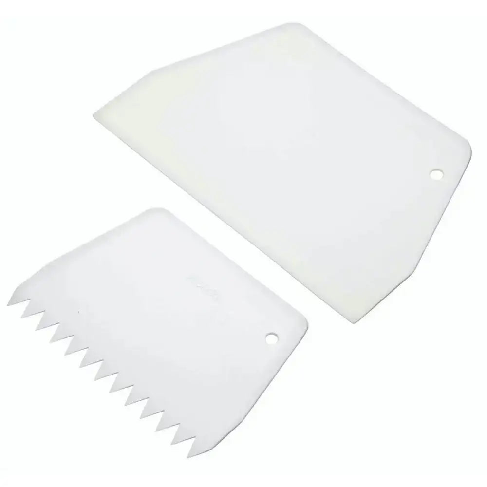 Two white plastic tools with serrated edges on a white background