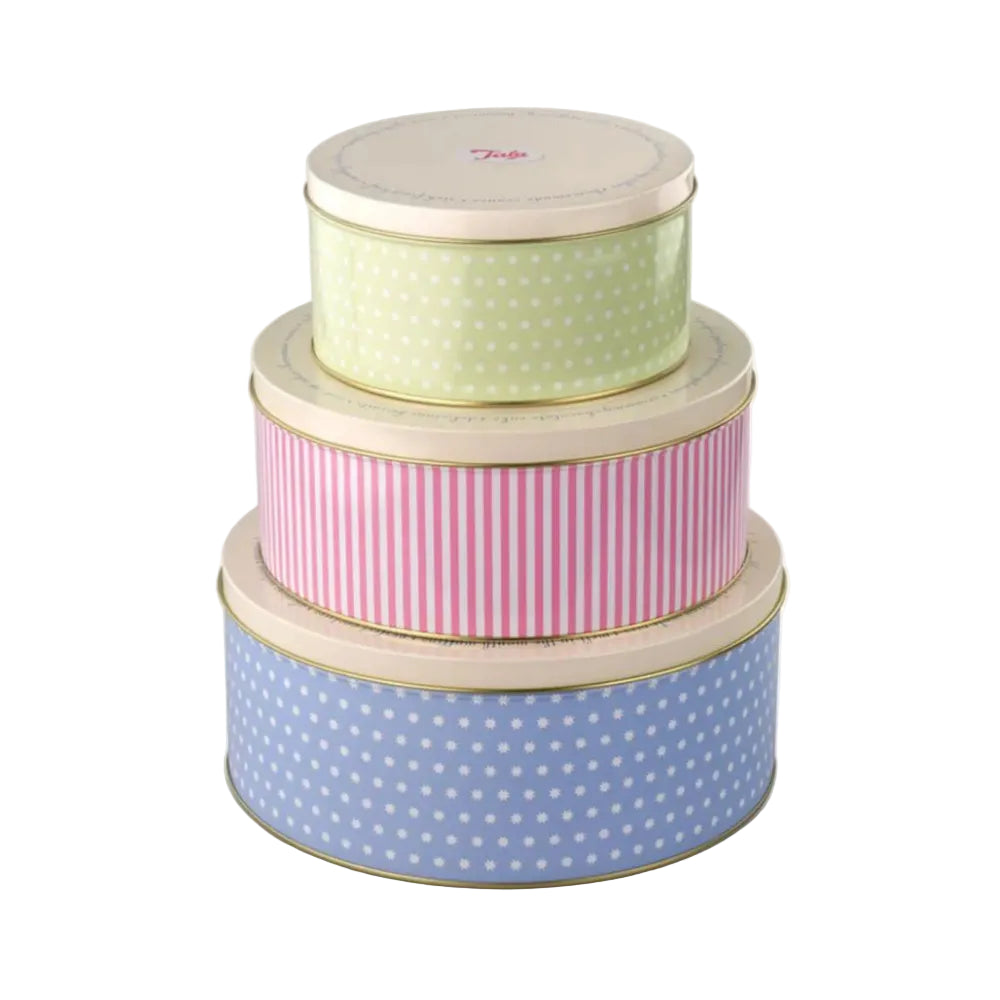 Set of three decorative tins with polka dot and striped patterns on a white background