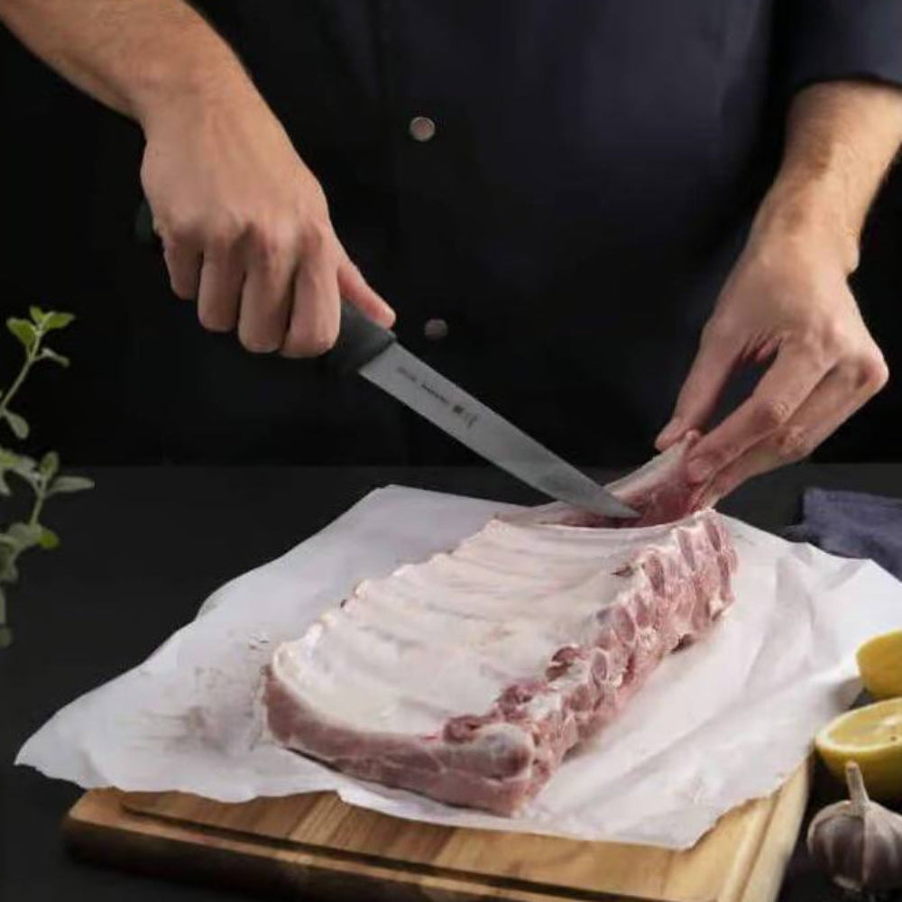 A person deboning ribs