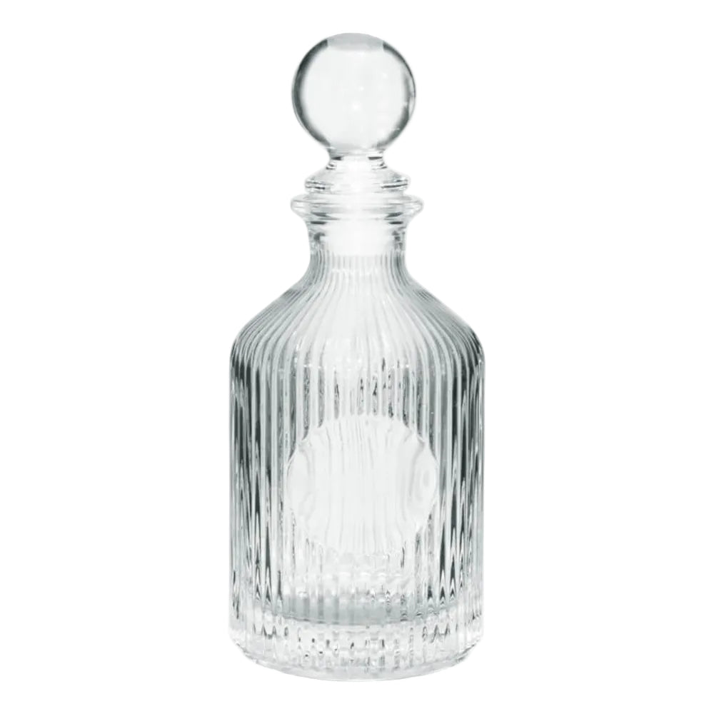 Clear glass decanter with a spherical stopper on a white background