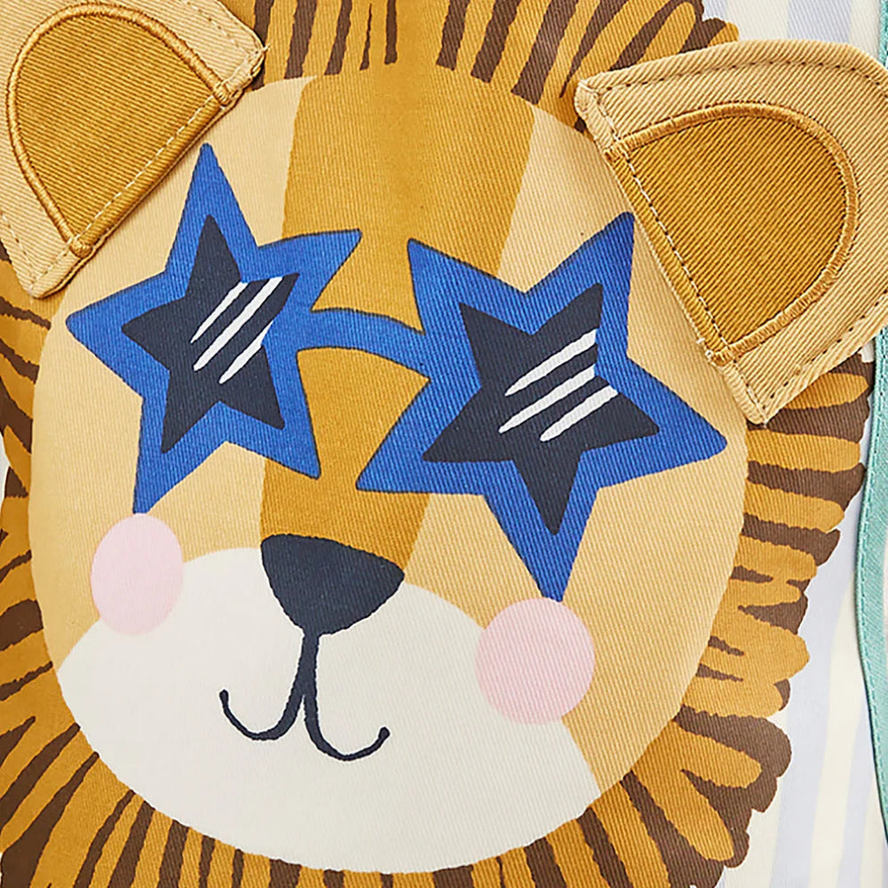 Close-up of a lion toy with star-shaped eyes on a white background