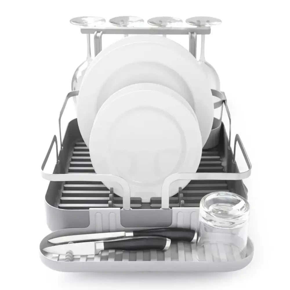 Dish drying rack with plates, bowls, and glasses on a white background
